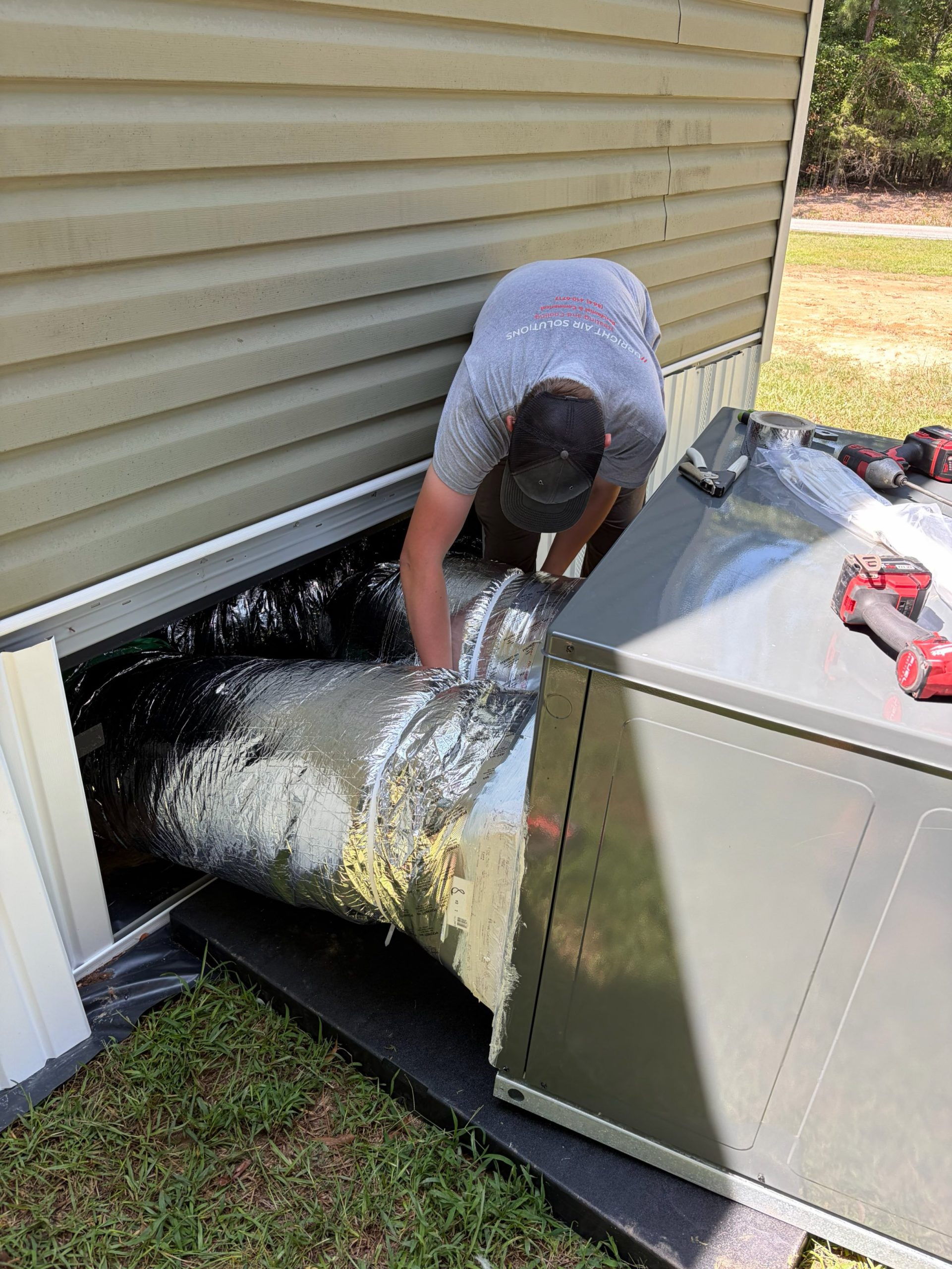 Upright Air Solutions technician working on an HVAC system installation in Upstate South Carolina.