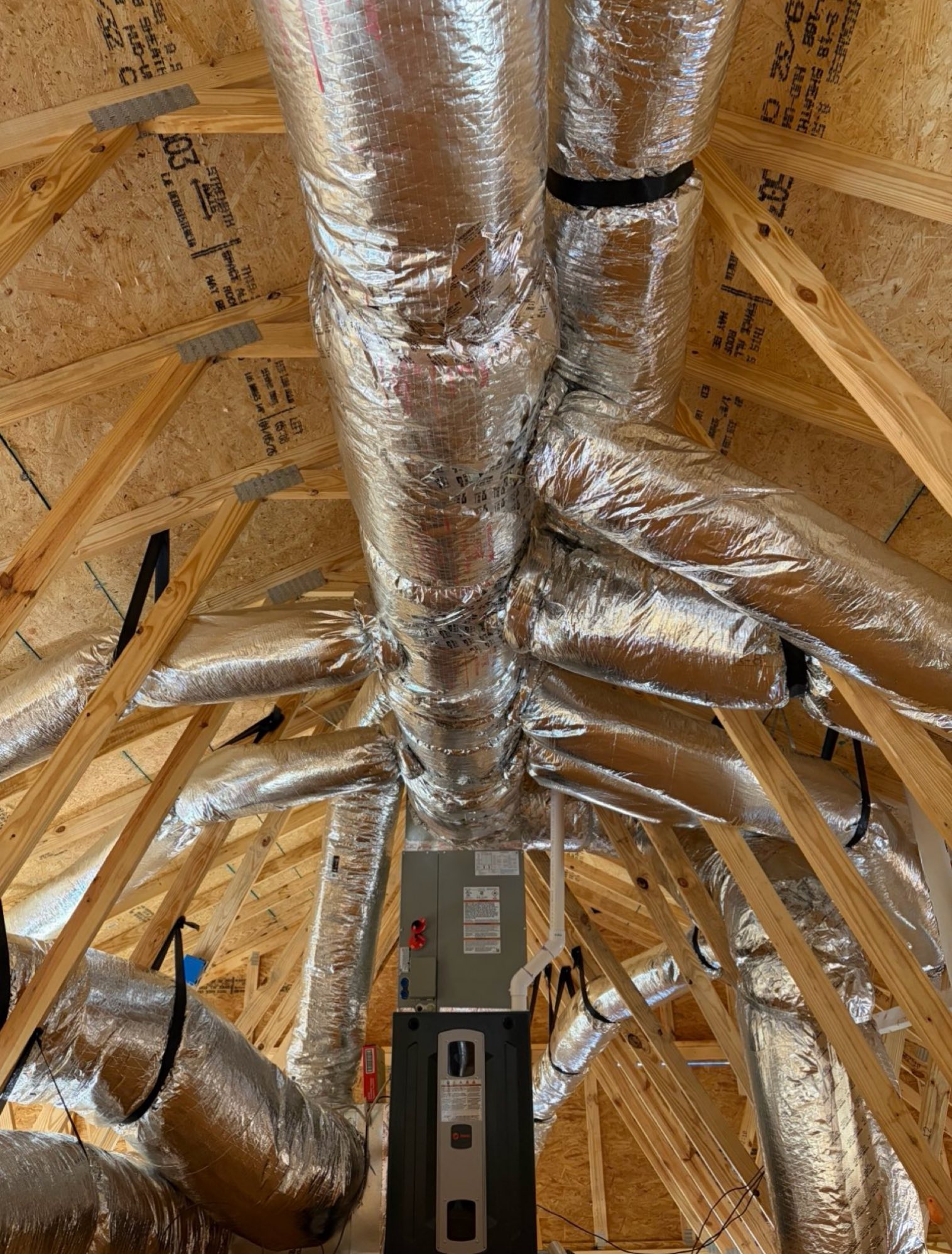 Insulated HVAC ductwork and air handler installed in a residential attic